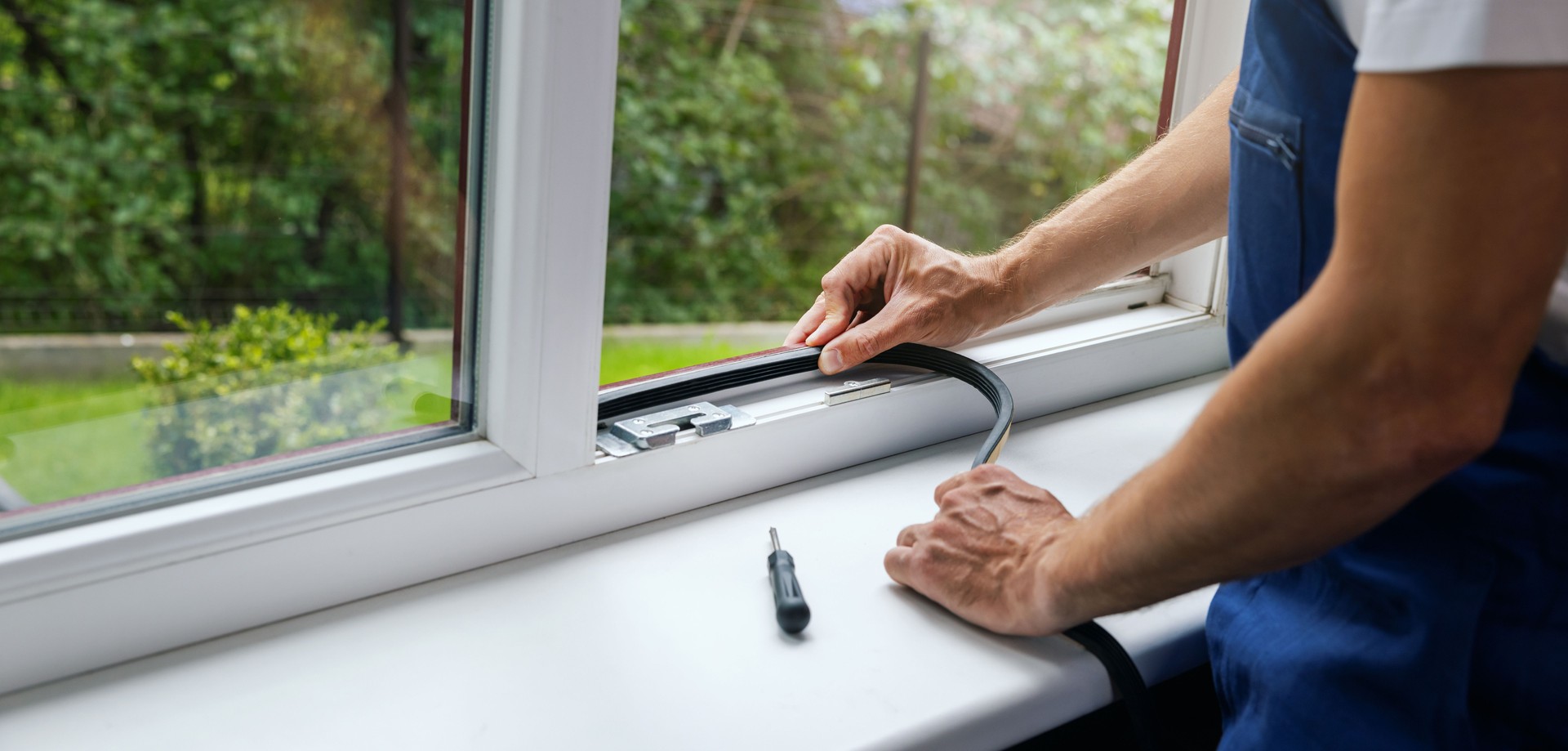 worker installing sealing tape on plastic window frame. copy space